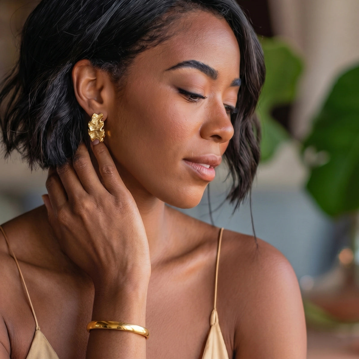 Aurelia Bangle gold-tone bracelet on a female model