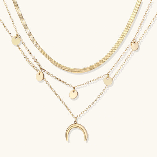 Golden Crescent Layer Set gold-tone layered necklace with on a cream studio background