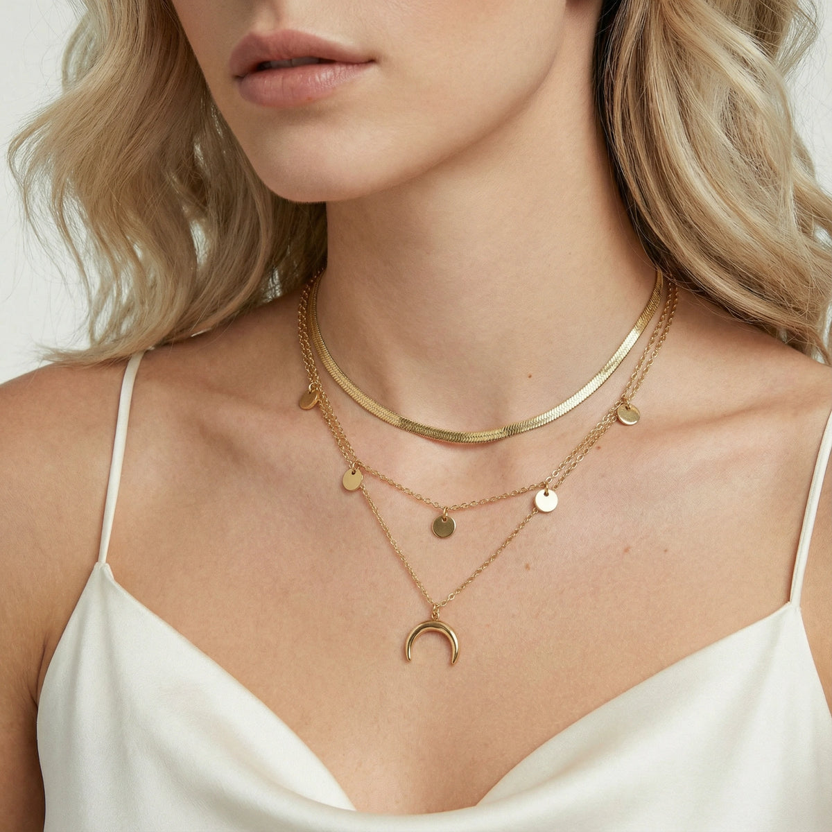 Golden Crescent Layer Set gold-tone layered necklace with symbols on a female modell