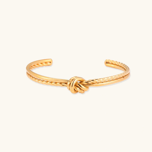 Amara Knot Cuff gold-tone knot style bracelet on a white background