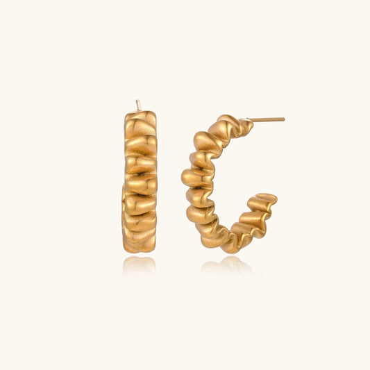 Vela Twist Hoops gold-tone earrings on a white background
