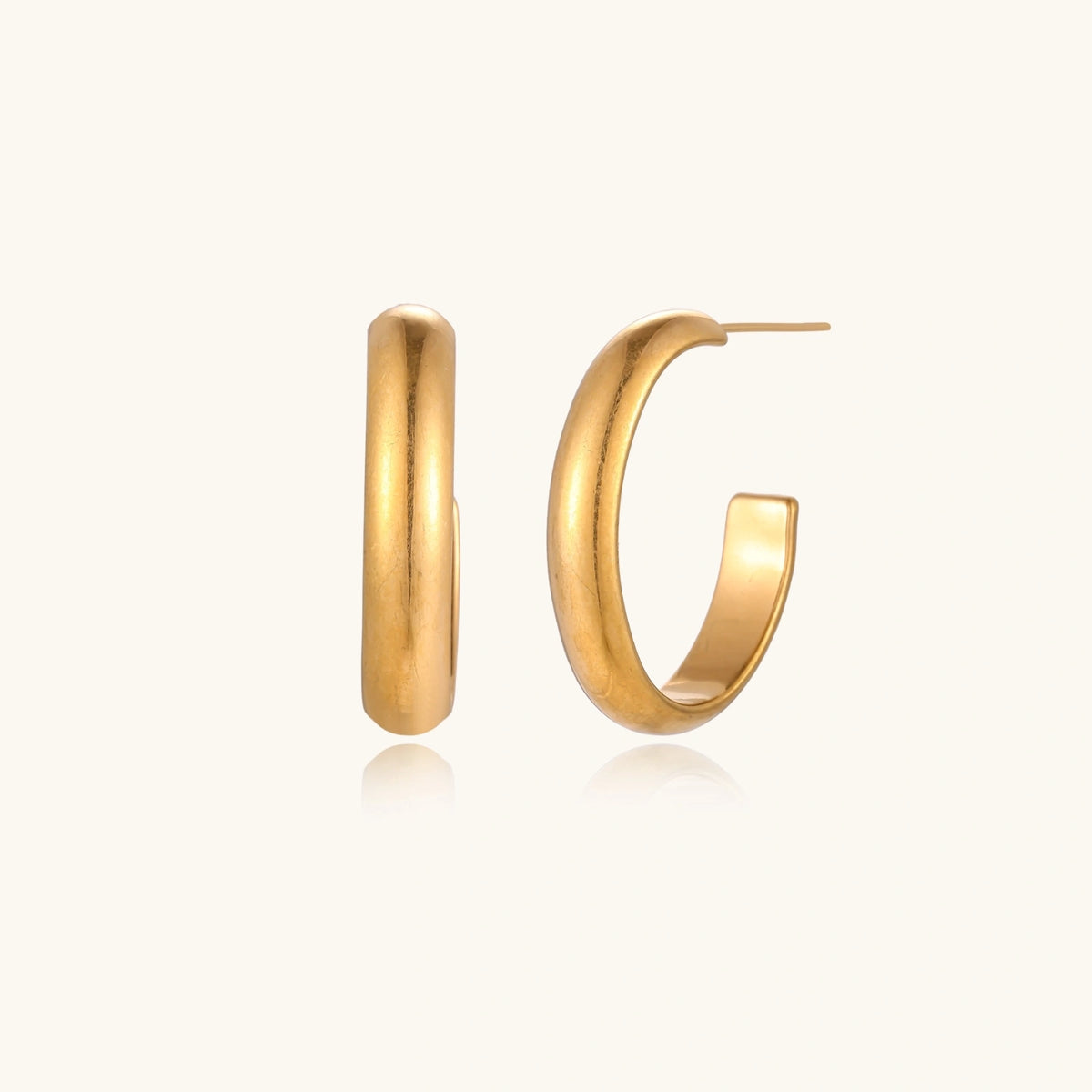 Veria Solea Hoops gold-tone earrings in a cream coloured studio setting