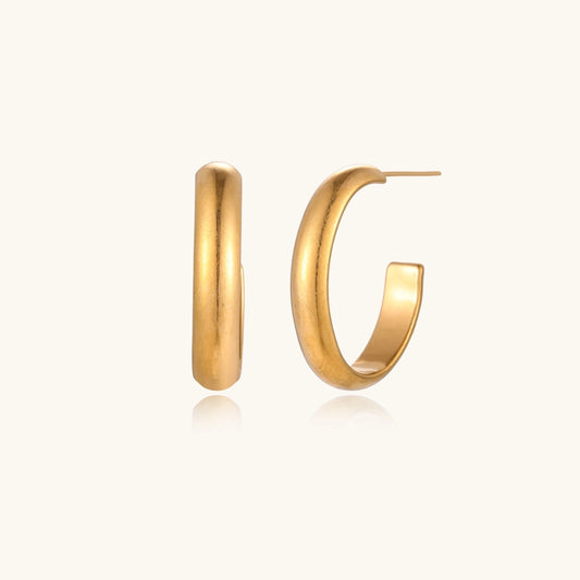 Veria Solea Hoops gold-tone earrings in a cream coloured studio setting
