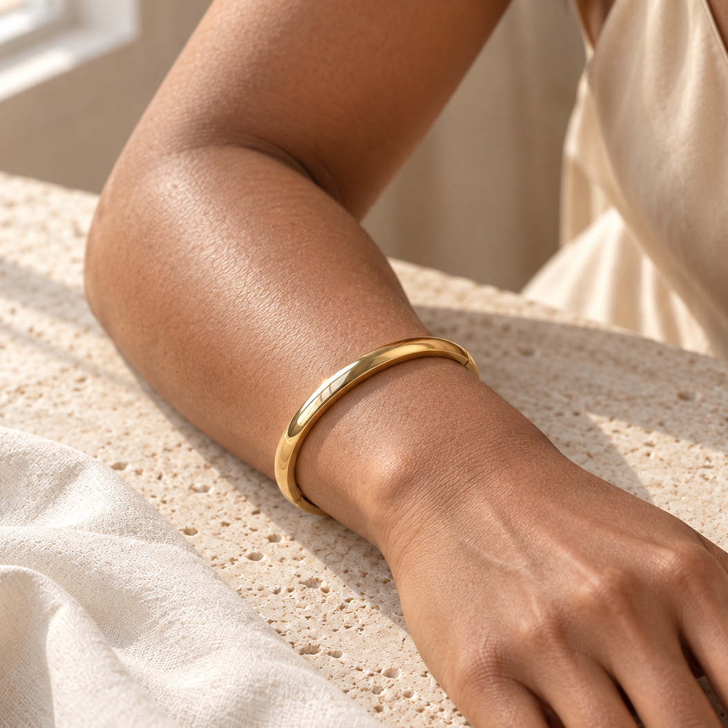 Aurelia Bangle gold-tone bracelet on a female model