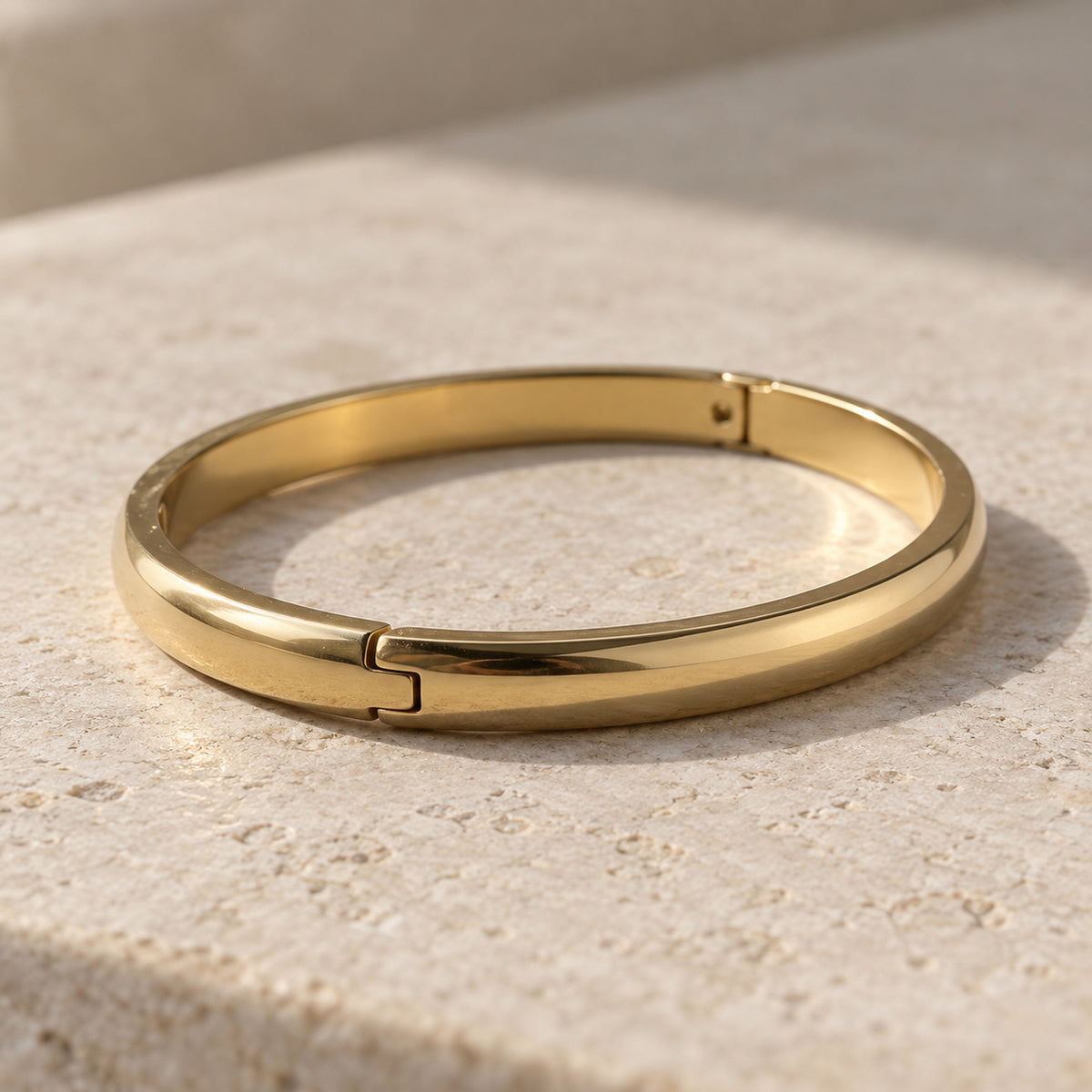 Aurelia Bangle gold-tone bracelet in a cream toned studio setting