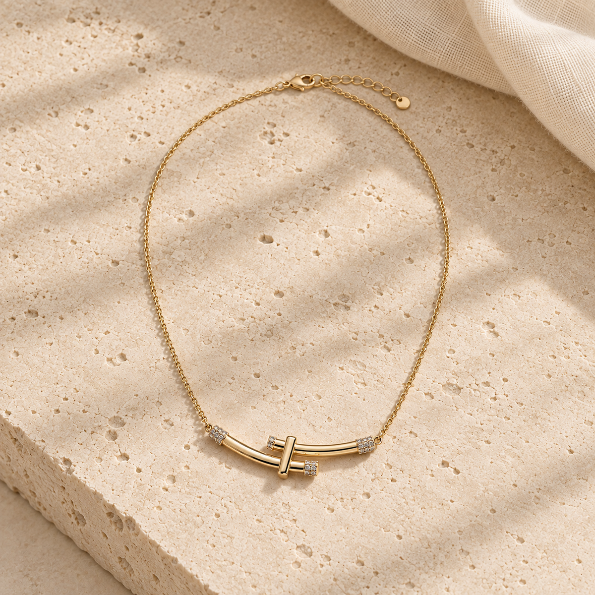 Bamboo Crystal Arc Necklace Gold-plated curved bar necklace with diamond accents on delicate chain against cream background