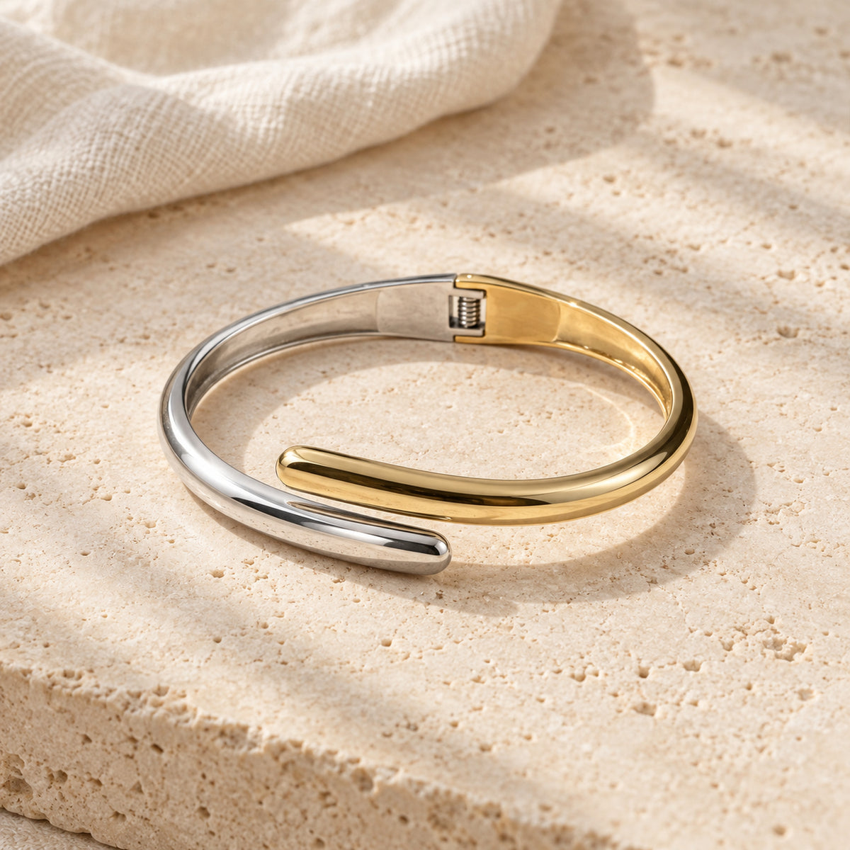 Elara Dual Tone Cuff silver and gold-tone bracelet in a cream tone studio setting