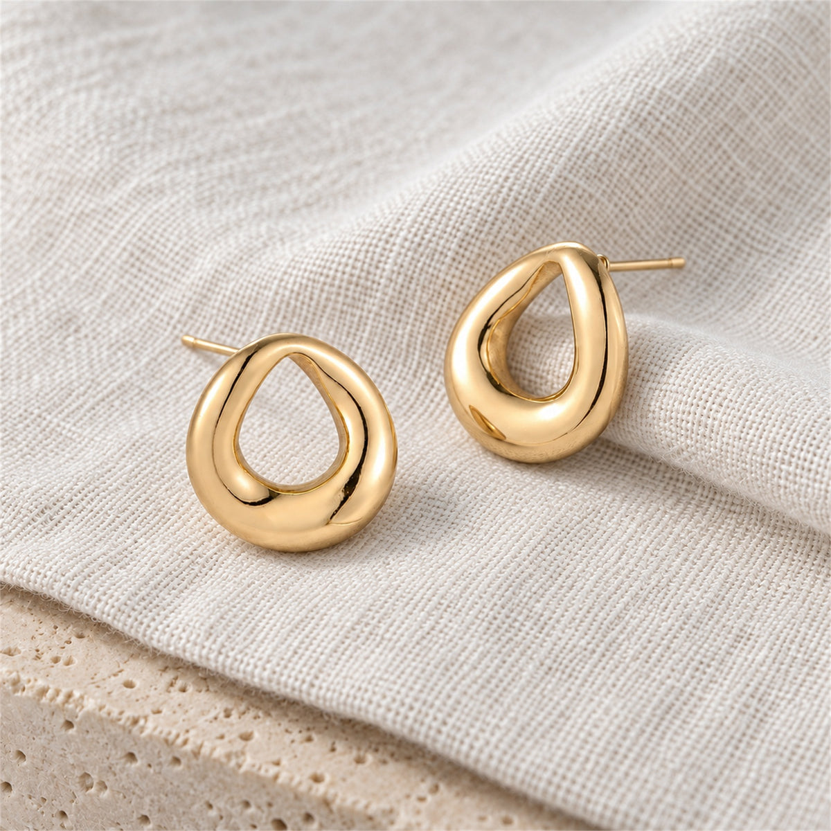Elara Loop Studs gold-tone earrings on a white background