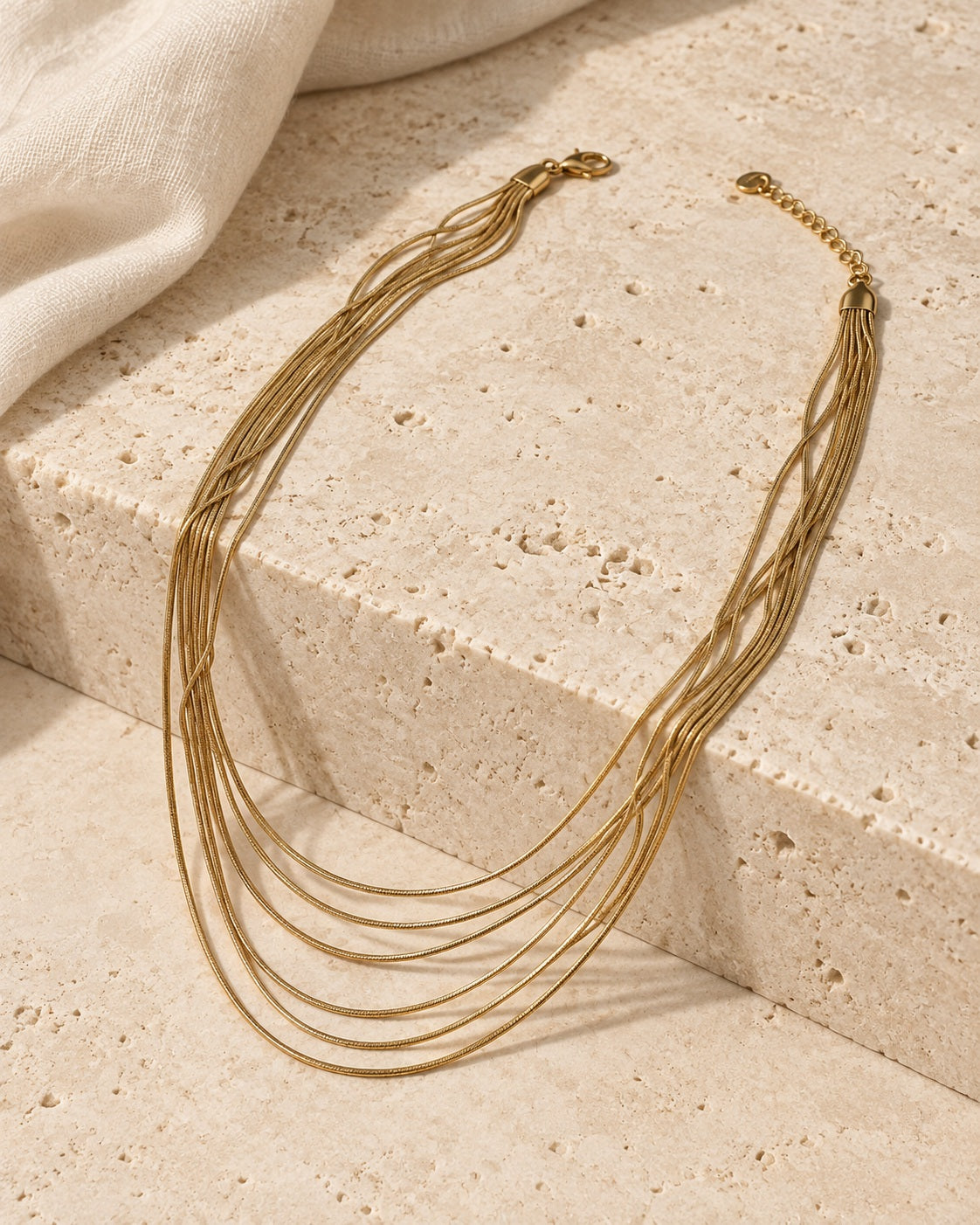 Golden Hour Layers Necklace gold-tone necklace on a cream studio background