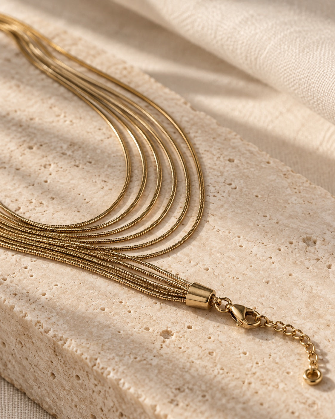 Golden Hour Layers Necklace gold-tone necklace on a cream studio background