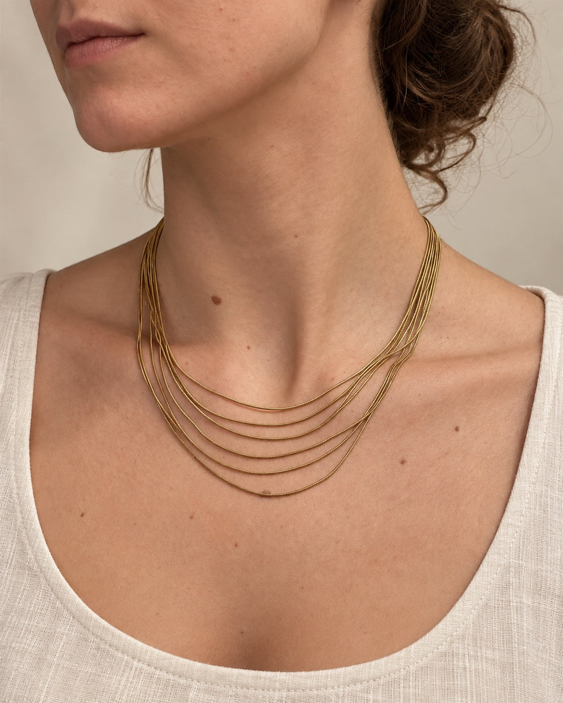 Golden Hour Layers Necklace gold-tone necklace on a female modell