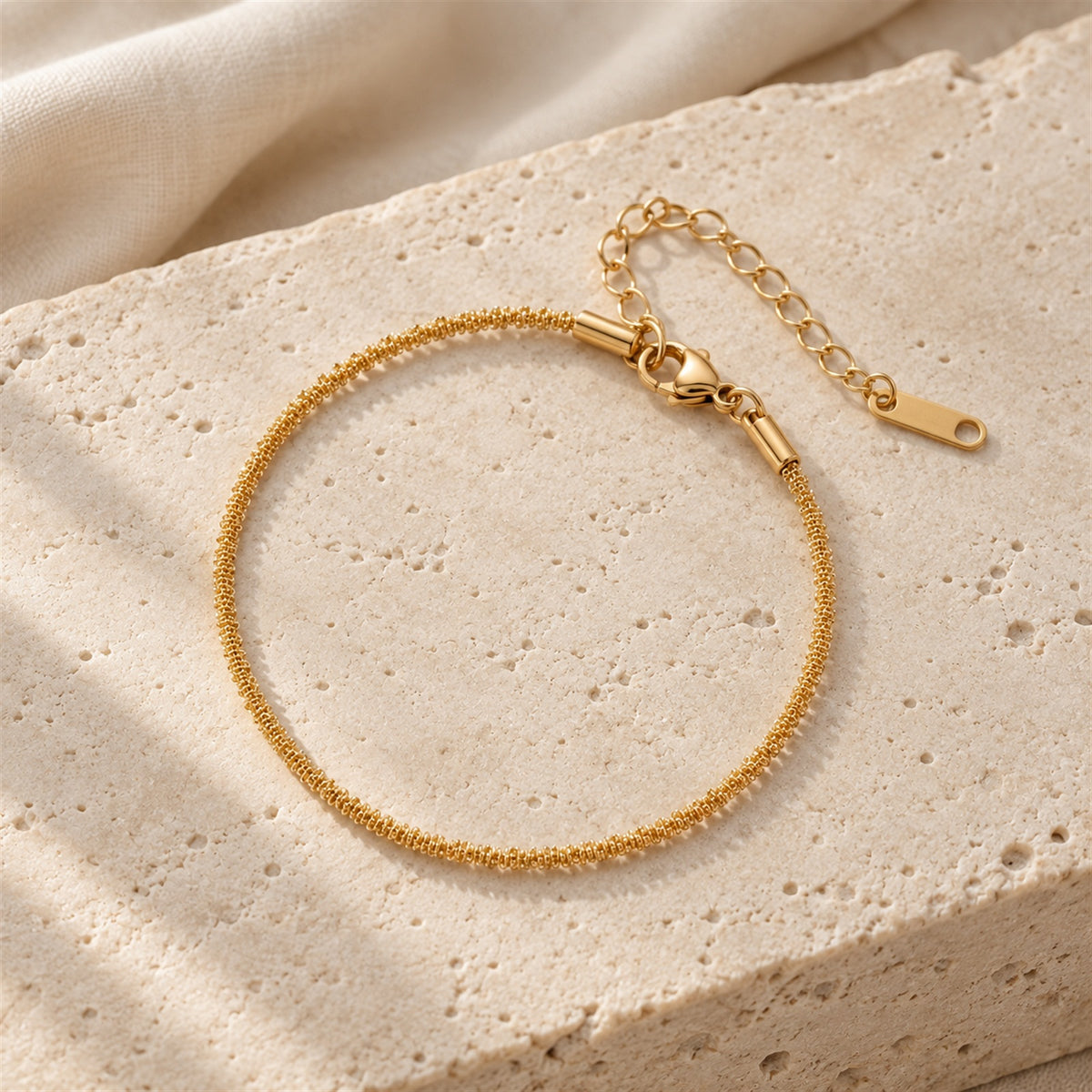 Liora Chain Bracelet gold-tone chain bracelet in a beige studio setting