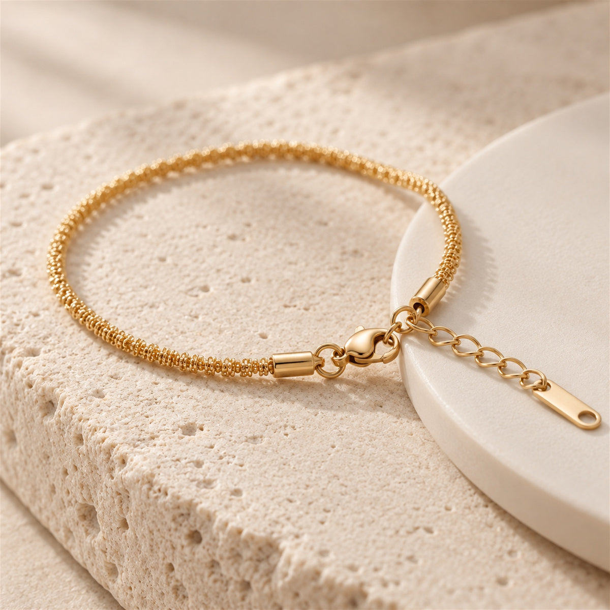 Liora Chain Bracelet gold-tone chain bracelet in a beige studio setting