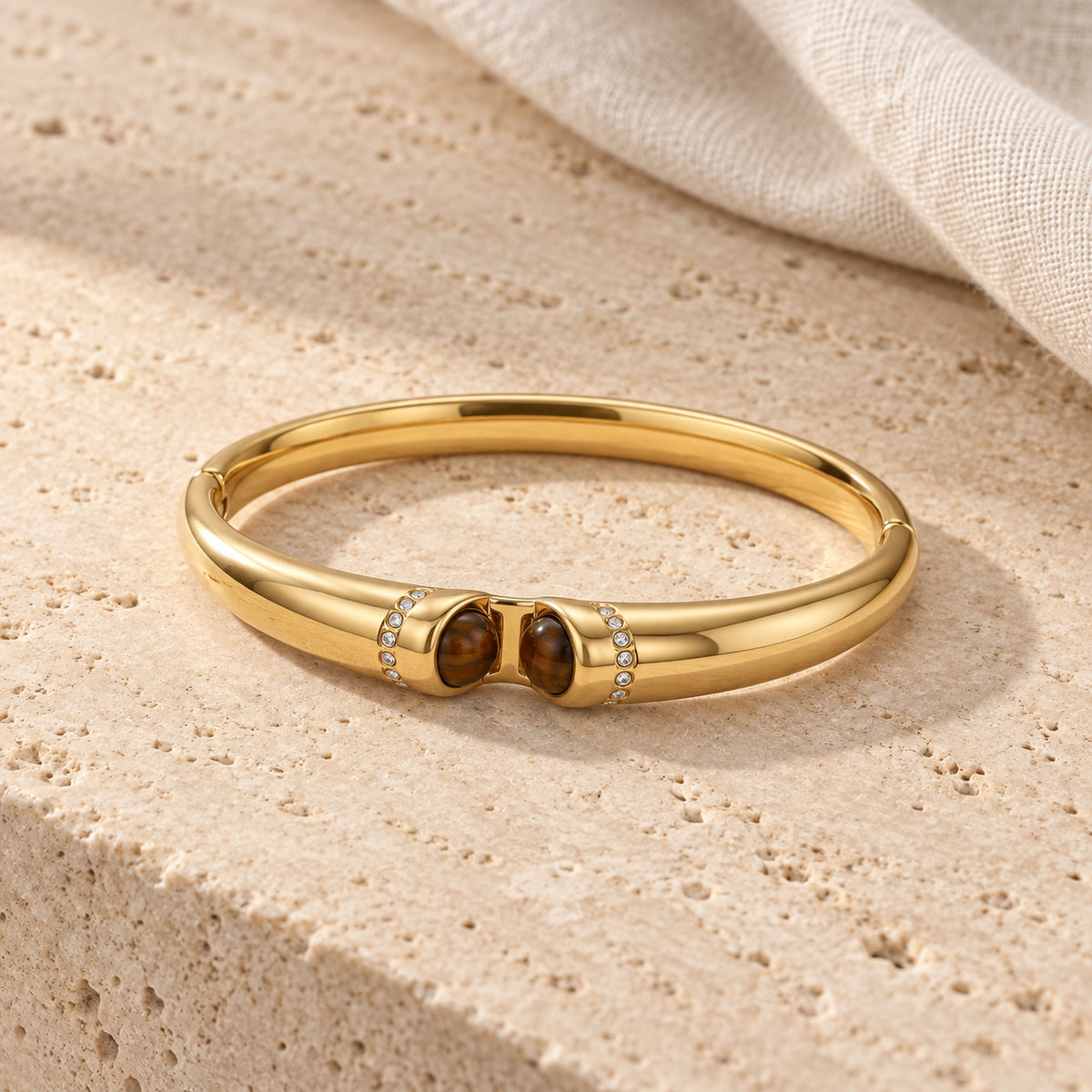 Tiger Eye Bangle gold-toned bracelet in a cream toned studio setting