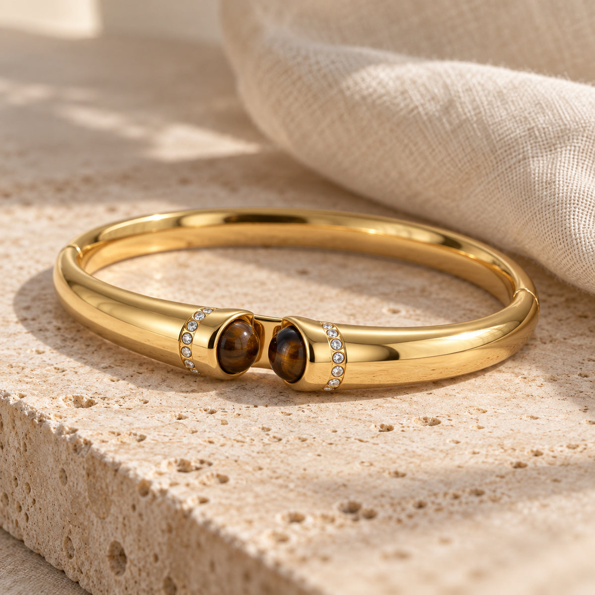 Tiger Eye Bangle gold-toned bracelet in a cream toned studio setting
